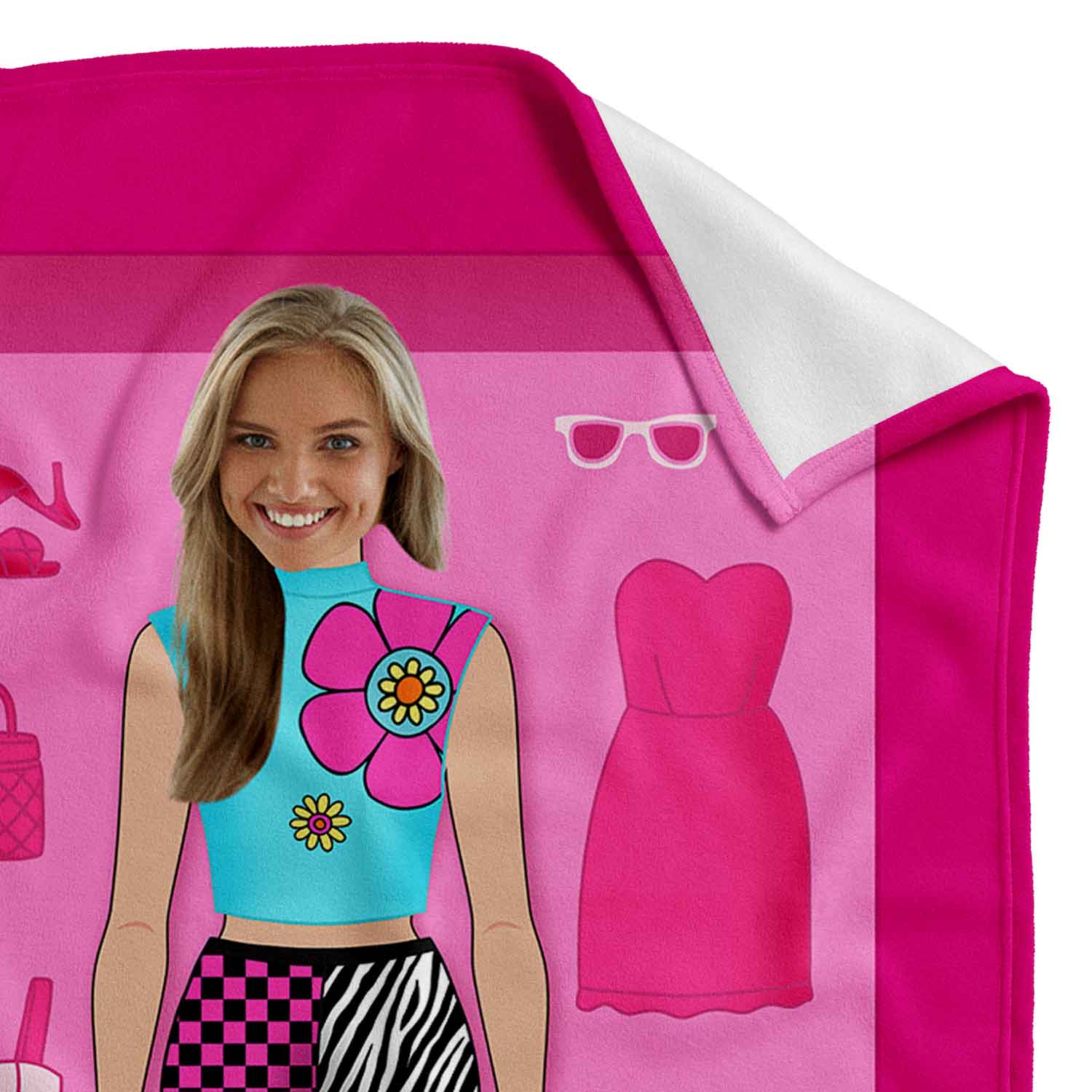 Pink towel with cartoon character and dress design, featuring a person wearing a blue top with a flower design.