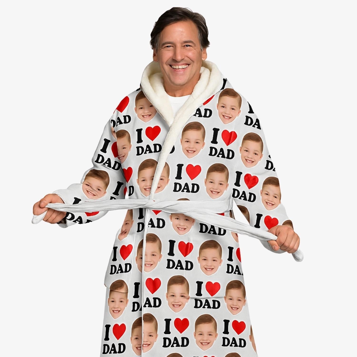Man wearing a personalized robe with 'I ❤️ DAD' text and child's face printed on it